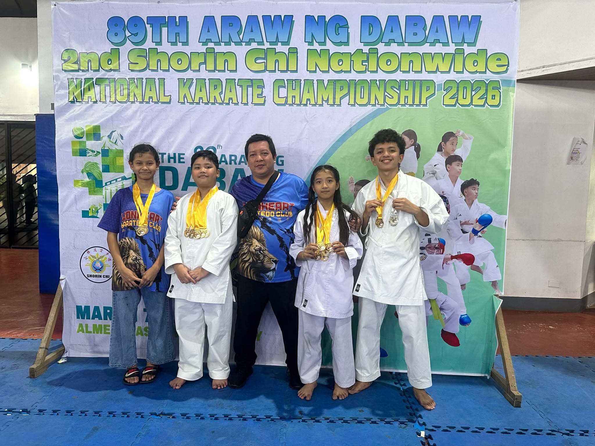 Four athletes and their coach at the 89th Araw ng Dabaw National Championship. The team achieved a fourth-place overall ranking, accumulating a total of 22 gold, 7 silver, and 1 bronze medals.