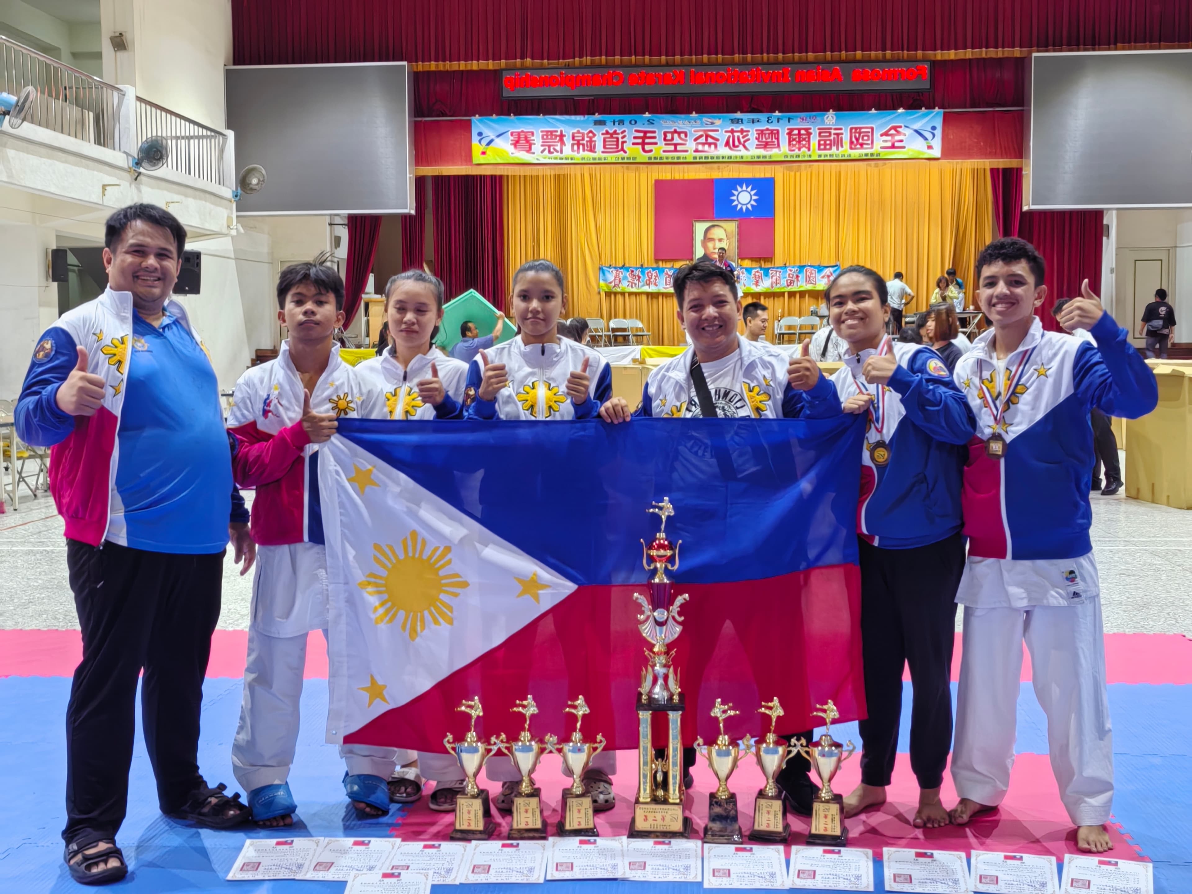 Members of the Lionheart Karate Association Philippines Inc. and Shorin Chi Davao delegation posing with national symbols and honors following their participation in the Formosa Asian Invitational Karate Championship in Taiwan.